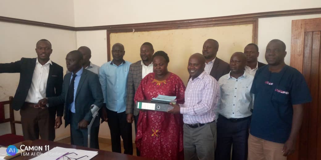 Chief Administrative Officer, Mr. Mukiibi Nasser receiving a copy of the performance assessment report during dissemination meeting of Local Government of service delivery (LGMSD) performance assessment results organised by the Office of the Prime Minister. Dissemination of Local Government Assessment report